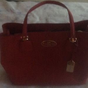 Red never been used coach bag.